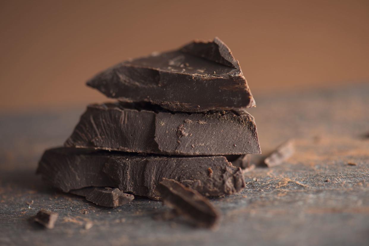 Closeup of dark chocolate chunks with a blurred stone background