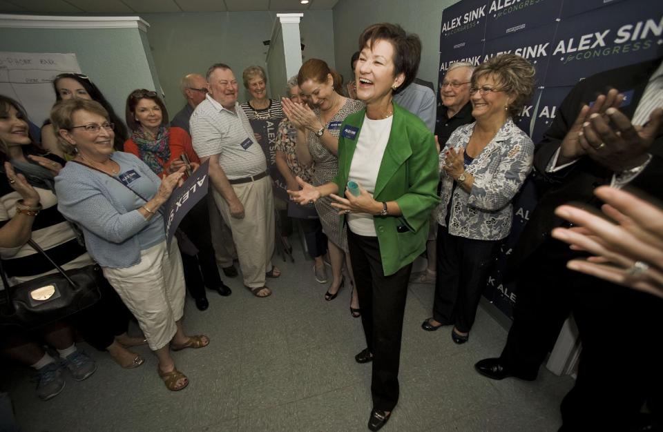 FILE This Nov. 23, 2013 file photo shows Florida Democratic Congressional candidate, Alex Sink, center, speaking at her campaign office in Clearwater, Fla. The special election in this stretch of coastal beach towns and retirement communities was expected to be a referendum on President Barack Obama’s health care law. Instead, in the waning days of the spirited campaign to replace the late Rep. Bill Young, another issue has roared to the forefront. (AP Photo/Steve Nesius, File)