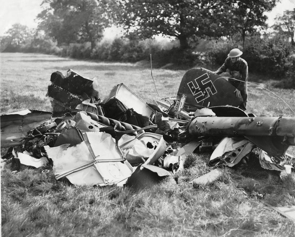 Battle of Britain: British soldier examining the wreckage of a downed German plane.