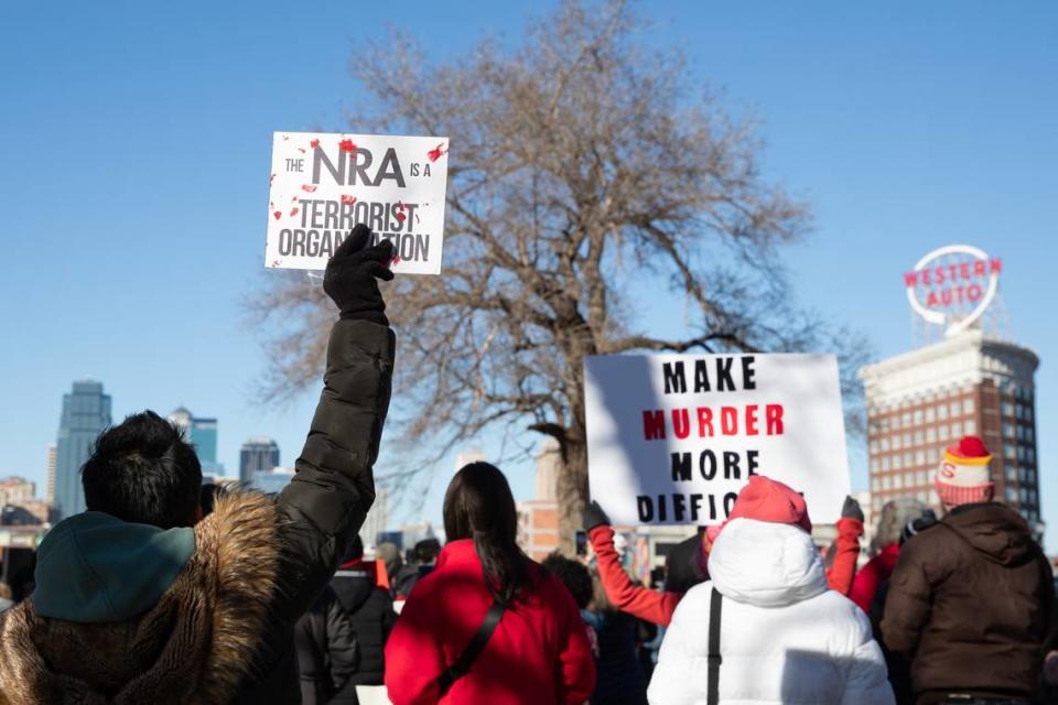 People hold signs to show support during the Kansas City Rally to End Gun Violence on Saturday at Washington Square Park.