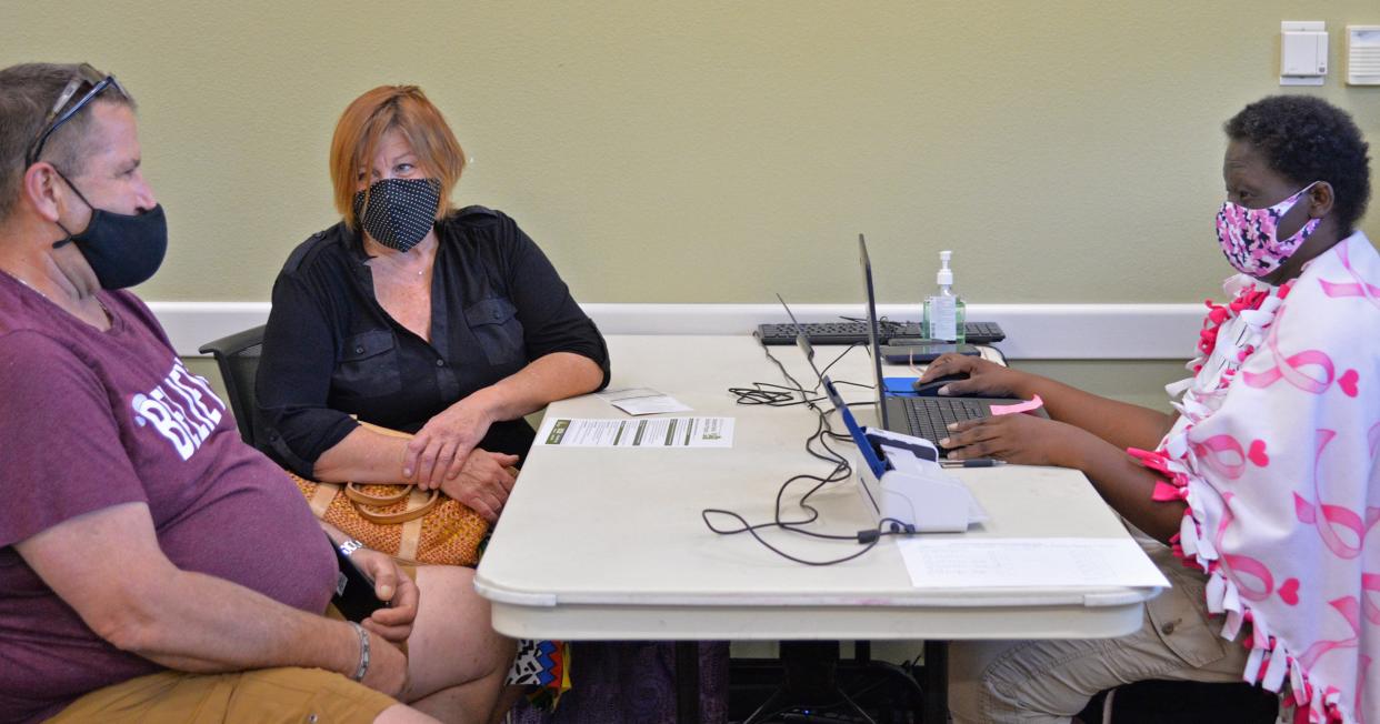 Margarett Lewis, a rental assistance ambassador, meets with Jeff Haugh and Cynthia Bornstein of Sarasota at Betty J. Johnson North Sarasota Public Library in May. Ambassadors help local residents apply for rental aid as part of Sarasota County’s Emergency Rental Assistance Program.