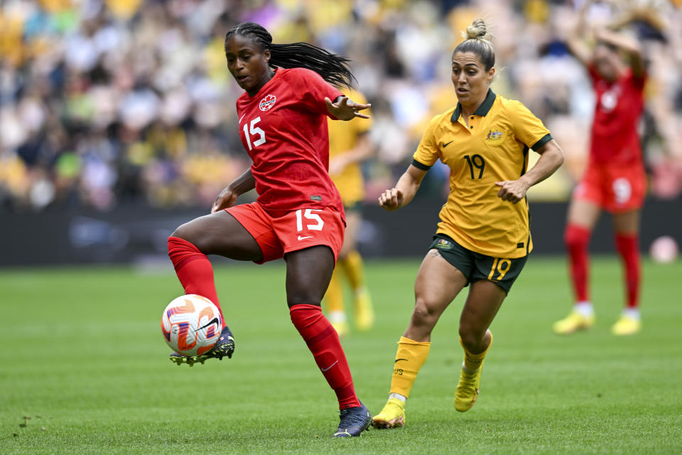 Nichelle Prince, left, of Canada battles for the ball with Katrina Gorry of Australia during the women's soccer friendly between Australia and Canada at Suncorp Stadium in Brisbane, Australia, Saturday, Sept. 3, 2022. (Darren England/AAP Image via AP)