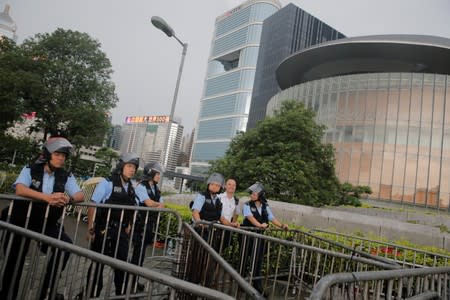 Police keep watch at a barrier surrounding the Legislative Council building after violent clashes in Hong Kong