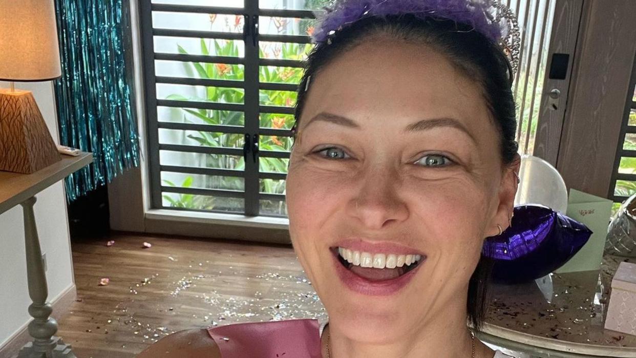 Emma Willis wearing birthday sash and crown to take selfie