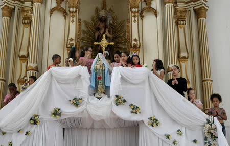 Children are seen at the church Sao Joao Batista near the dam at Brazilian miner Vale's Gongo Soco mine, amid reports that it may soon collapse, in Barao de Cocais, Minas Gerais state, Brazil May 24, 2019. REUTERS/Washington Alves