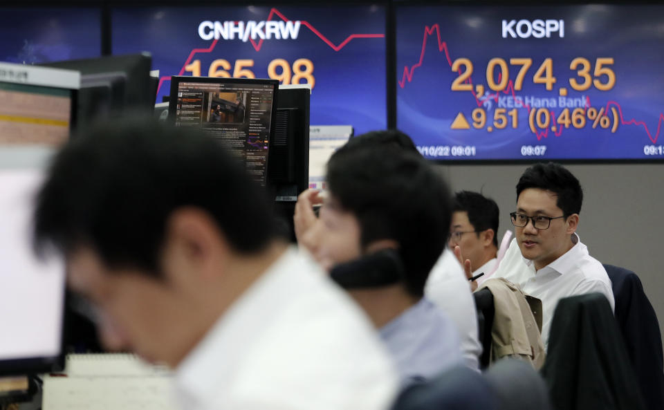 Currency traders work at the foreign exchange dealing room of the KEB Hana Bank headquarters in Seoul, South Korea, Tuesday, Oct. 22, 2019. Shares are gaining in Asia after upbeat comments from President Donald Trump and other U.S. officials on the status of trade negotiations with China. (AP Photo/Ahn Young-joon)