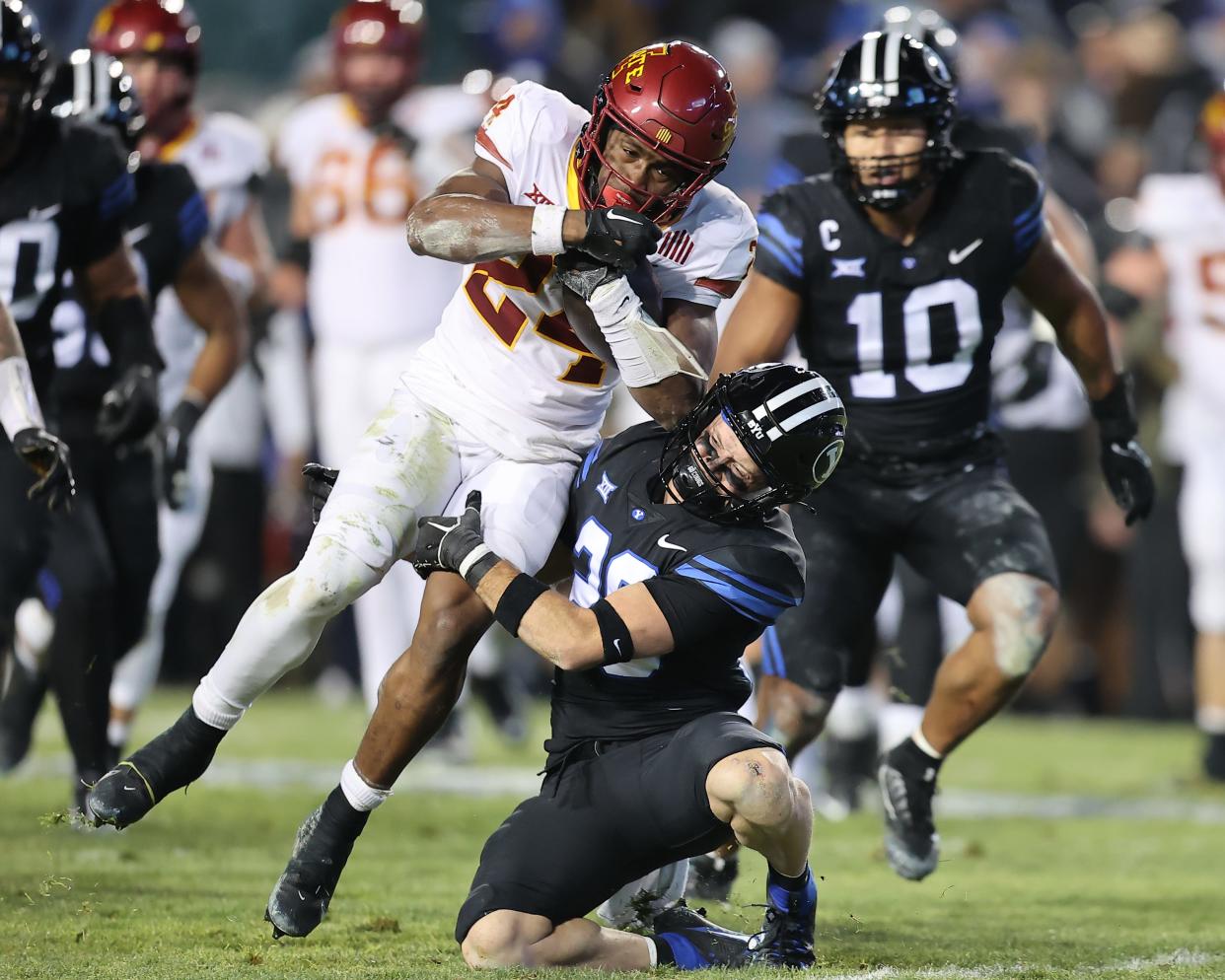 Iowa State running back Abu Sama III (24) attemps to run through defenders against BYU on Nov. 11.