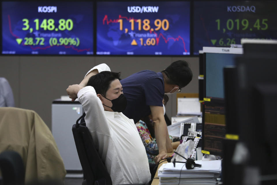 A currency trader watches monitors at the foreign exchange dealing room of the KEB Hana Bank headquarters in Seoul, South Korea, Friday, April 23, 2021. Asian stock markets were mixed Friday after Wall Street fell following a report that President Joe Biden will propose raising taxes on wealthy investors. (AP Photo/Ahn Young-joon)