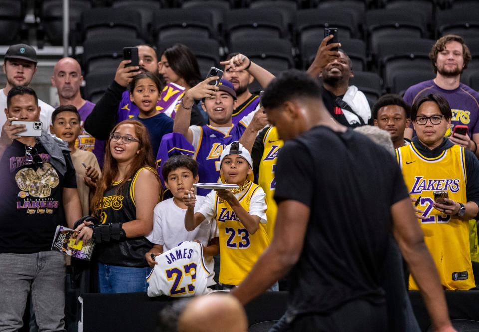 Los Angeles Lakers fans look to try and get autographs before their preseason game at Acrisure Arena in Palm Desert on Thursday.