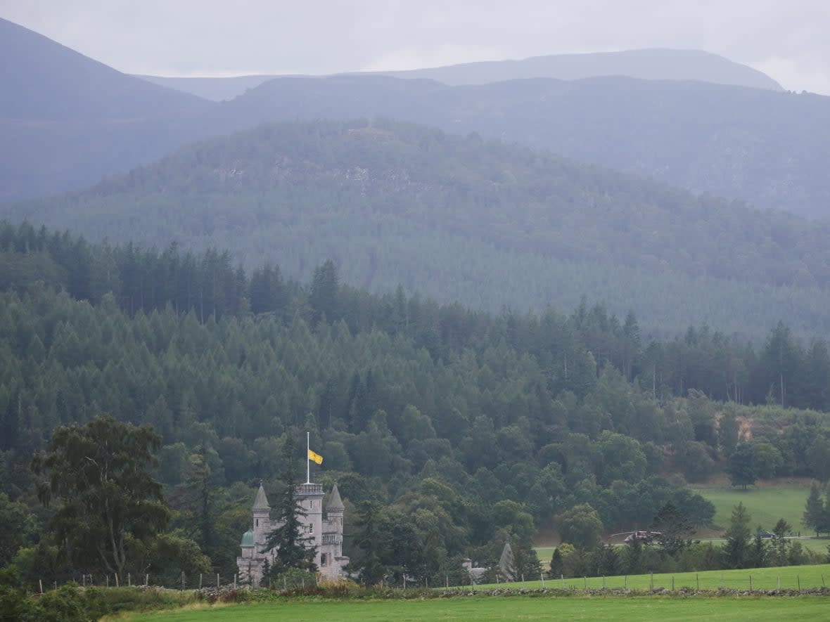 A view of a flag flying at half mast at Balmoral Castle on Friday, following the passing of Queen Elizabeth in Balmoral, Scotland. The Queen had close ties to Scotland, and without her, the issue of independence may rise again. (Russell Cheyne/Reuters - image credit)