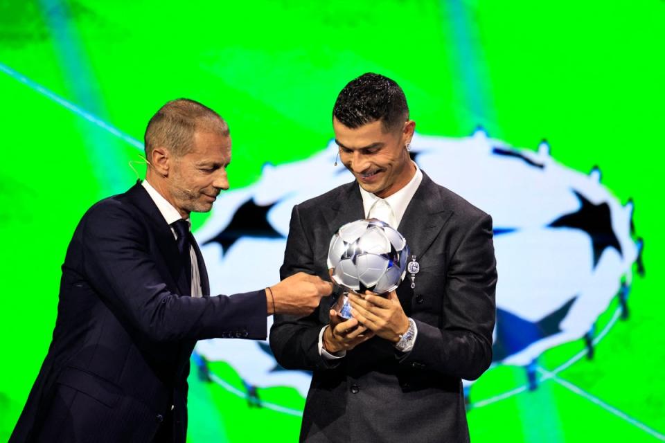 Ceferin presents a prize to Cristiano Ronaldo at the Champions League draw (AFP via Getty Images)