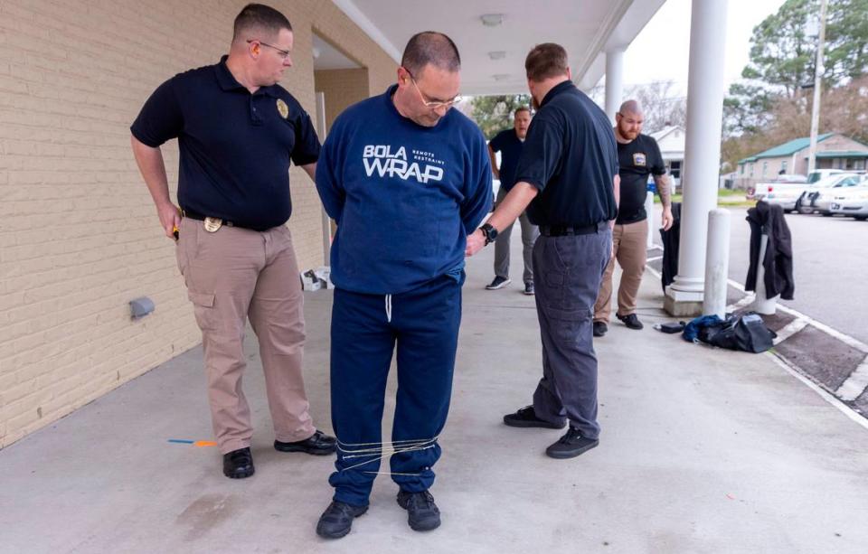 Edenton police officers train with BolaWrap, a restraint device that police departments across the country are trying. Edenton was the first department to use BolaWrap in North Carolina in 2019.