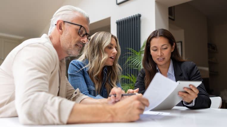 A couple meets with their financial advisor to talk about purchasing an annuity.