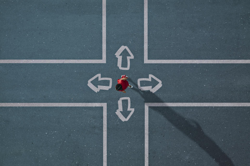 Group of children photographed from above on various painted tarmac surface at sunset. Photo: Getty