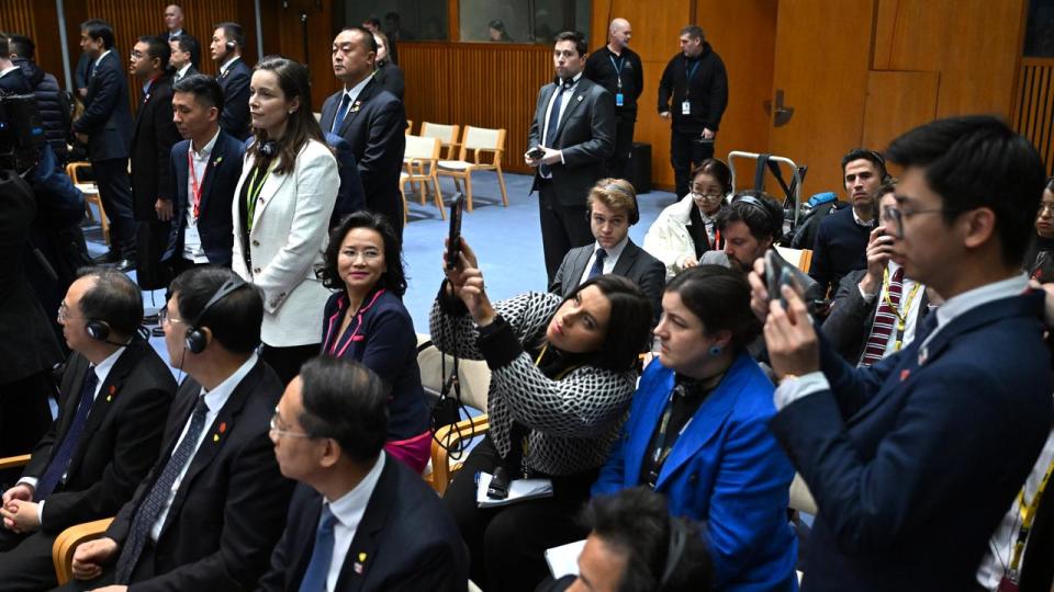 Journalists and officials at a media event in Parliament House.