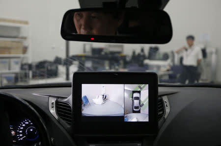 FILE PHOTO: A researcher demonstrates an all around view system at Hyundai Mobis Research Centre in Yongin July 16, 2014. REUTERS/Kim Hong-Ji