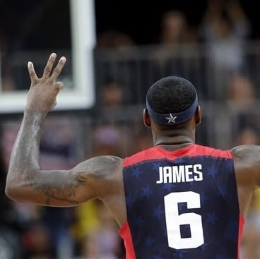 USA's Lebron James (6) signals after scoring with a three point basket during a preliminary men's basketball game against Lithuania at the 2012 Summer Olympics, Saturday, Aug. 4, 2012, in London. (AP Photo/Eric Gay)