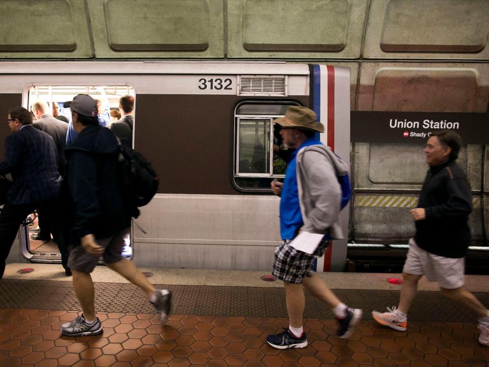 People run onto the Shady Grove bound Red Line Metro as it is delayed in Union Station in Washington, Monday, September 21, 2015.