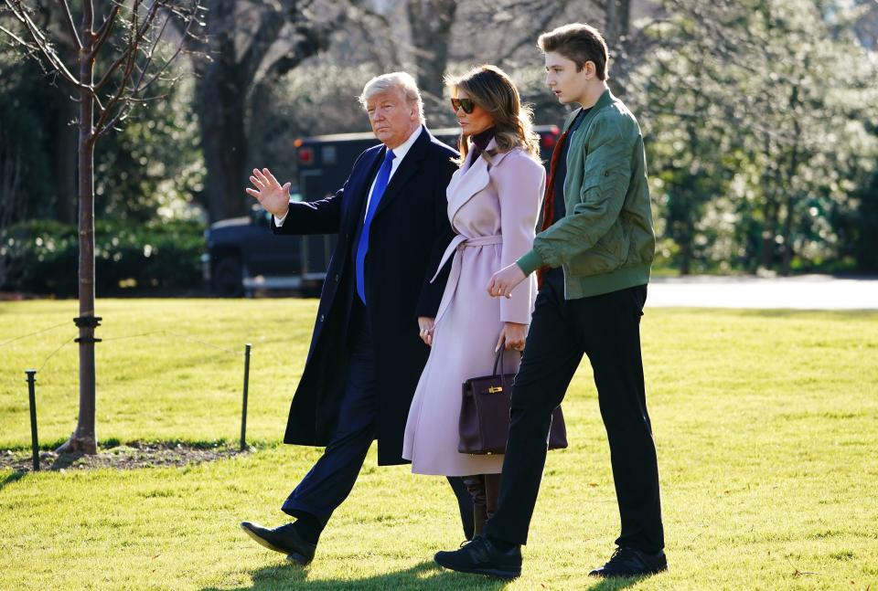 US President Donald Trump, First Lady Melania Trump and son Barron Trump make their way to board Marine One from the South Lawn of the White House in Washington, DC on January 17, 2020. Trump is traveling to Palm Beach, Florida.