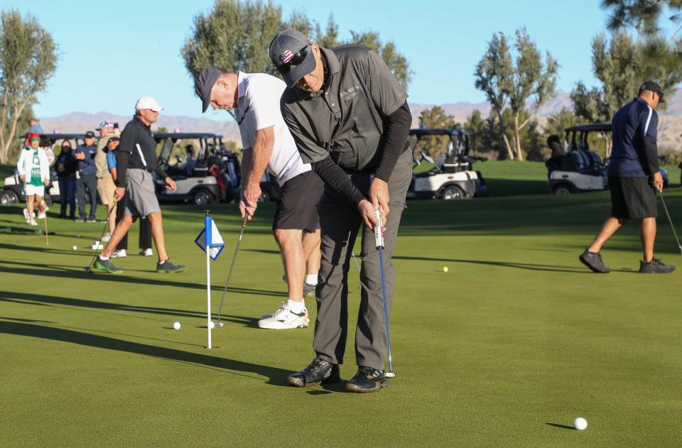 Golfers warm up on the putting green before the Clubs for Kids Golf Tournament at Classic Club in Palm Desert, Calif., Dec. 13, 2023.