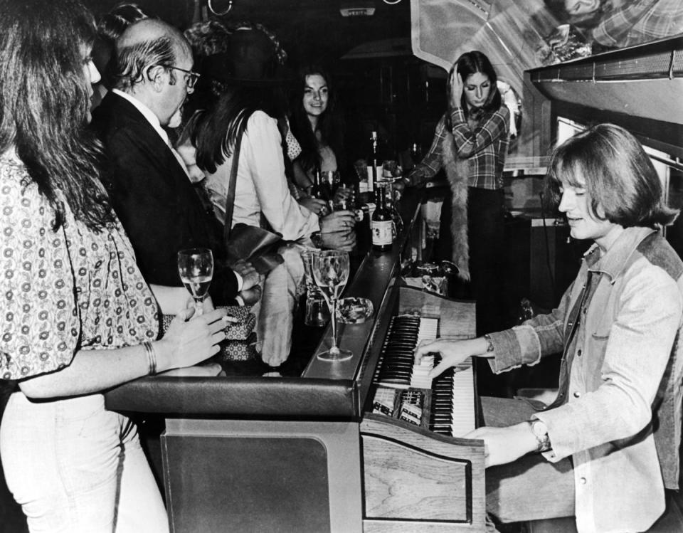 <p>John Paul Jones of Led Zeppelin plays electric organ on board a private Boeing 720B airliner known as "The Starship" used by the band on tour in 1973. </p>