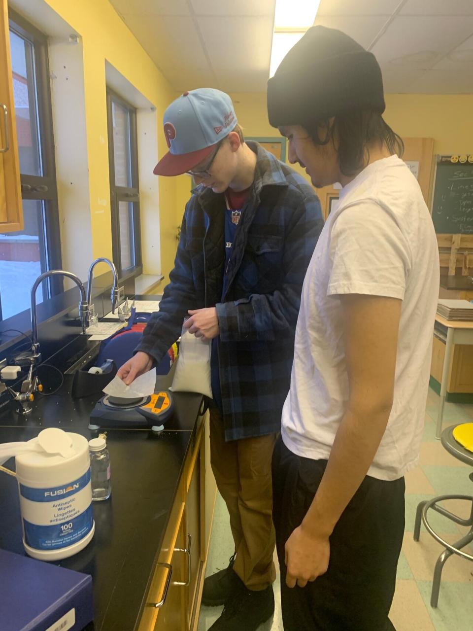 Kristopher Neeposh and Rory Henry-Felstead of Nemaska, Que., work on their science project, looking at natural fire retardants found in the boreal forest.