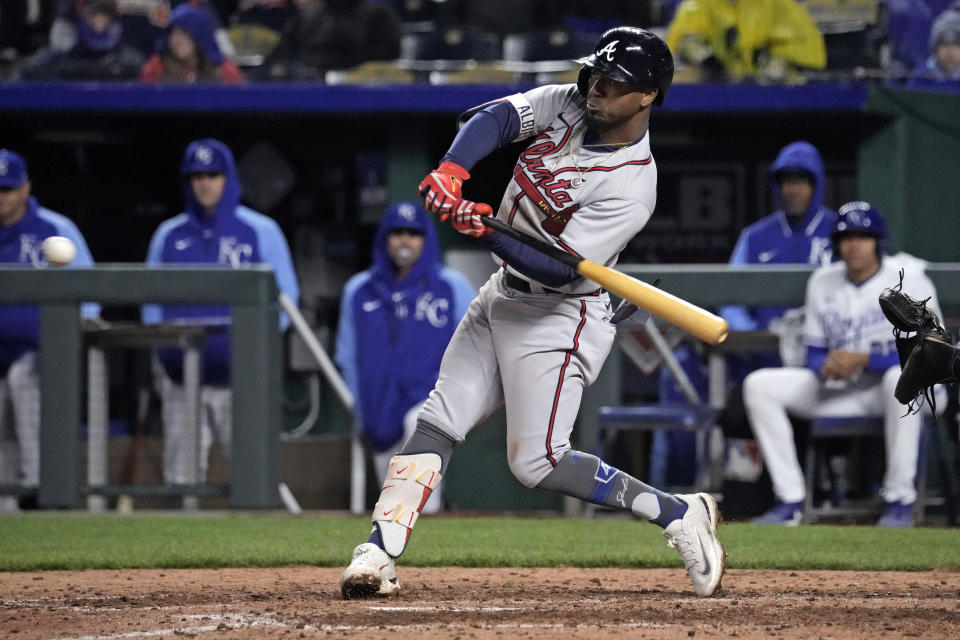 Atlanta Braves' Ozzie Albies hits a two-run single during the eighth inning of a baseball game against the Kansas City Royals Saturday, April 15, 2023, in Kansas City, Mo. The Braves won 9-3. (AP Photo/Charlie Riedel)