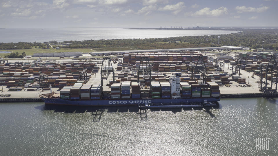 a photo of a container ship unloading imports