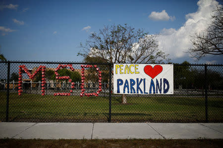 The initials of Marjory Stoneman Douglas High School and a placard are placed on the fence at Park Trails Elementary School, following a mass shooting in Parkland, Florida, U.S., April 9, 2018. REUTERS/Carlos Garcia Rawlins