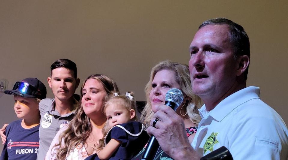 Montgomery County Sheriff John Fuson, near, is joined by his family following his reelection Thursday.