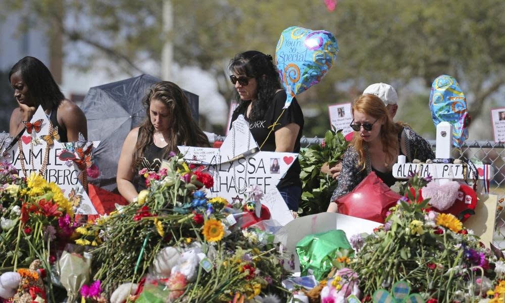 A makeshift memorial for victims of the shooting at Marjory Stoneman Douglas High School in Parkland, Florida, in February 2018. After a mass shooting, community members' trauma lingers months or years after media attention fades. (Photo: The Guardian)