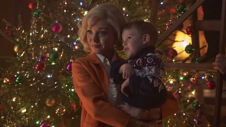  Trixie Franklin (HELEN GEORGE) and Jonty Aylward (ARCHIE O'CALLAGHAN) in Call the Midwife standing in front of a Christmas tree . 