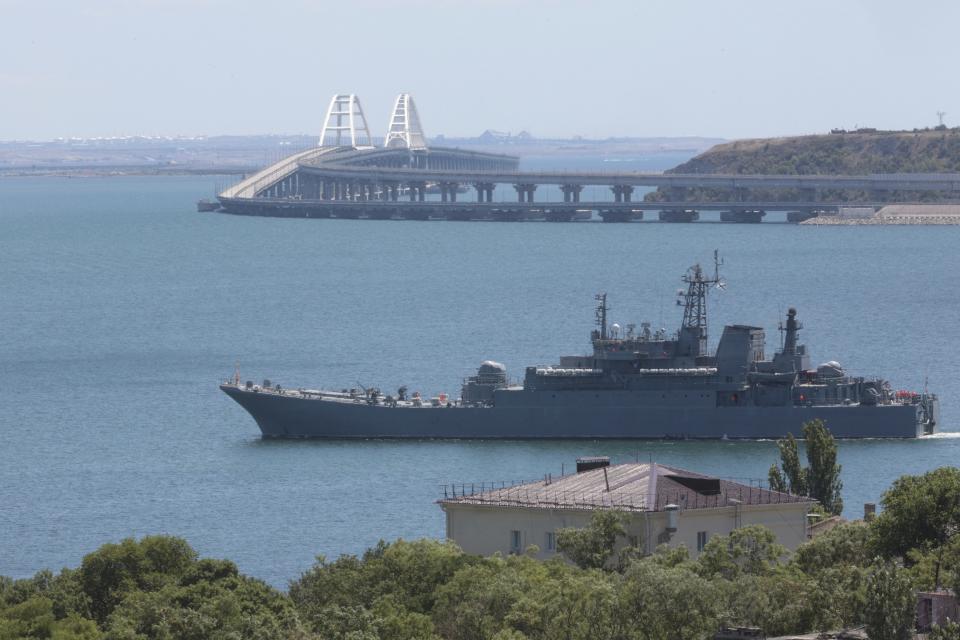 FILE - A Russian military landing ship, which now transports cars and people between Crimea and Taman because the Crimean Bridge connecting Russian mainland and Crimean peninsula over the Kerch Strait is closed, sails not far from Kerch, Crimea, on Monday, July 17, 2023. The Crimean Peninsula's balmy beaches have been vacation spots for Russian czars and has hosted history-shaking meetings of world leaders. And it has been the site of ethnic persecutions, forced deportations and political repression. Now, as Russia’s war in Ukraine enters its 18th month, the Black Sea peninsula is again both a playground and a battleground. (AP Photo, File)