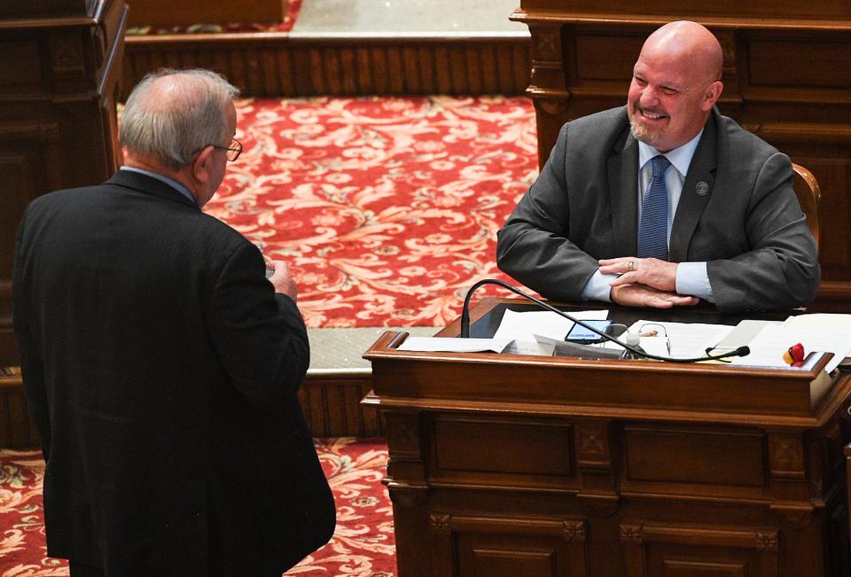 Sen. Jason Schultz, R-Schleswig, right, mingles during recess inside the Iowa Senate chamber on Tuesday, March 29, 2022, in Des Moines.