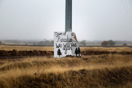 A handwritten sign is seen on a telephone poll on the road to Paradise in Chico, California, U.S. November 21, 2018. REUTERS/Elijah Nouvelage