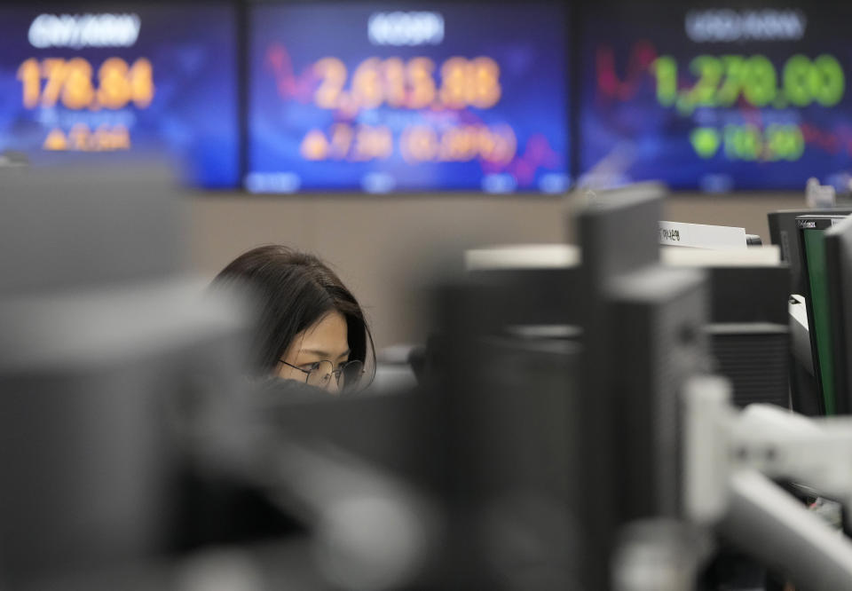 A currency trader watches monitors at the foreign exchange dealing room of the KEB Hana Bank headquarters in Seoul, South Korea, Friday, June 16, 2023. Asian shares logged moderate gains on Friday after Wall Street benchmarks swept higher, extending their longest rally in a year and a half. (AP Photo/Ahn Young-joon)