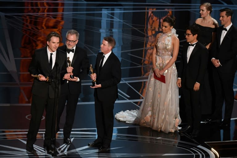 Byron Howard (L), Rich Moore (C) and producer Clark Spencer deliver a speech after they won the award for Best Animated Feature Film for "Zootopia" at the 89th Oscars on February 26, 2017 in Hollywood, California