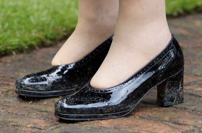 FILE PHOTO: The muddy shoes of Britain's Queen Elizabeth are seen after a hailstorm during her visit to the "Wild London" exhibition in Richmond, west London