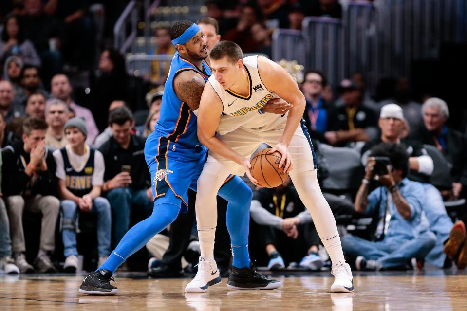 Carmelo Anthony guards Nikola Jokic during a 2017 game.