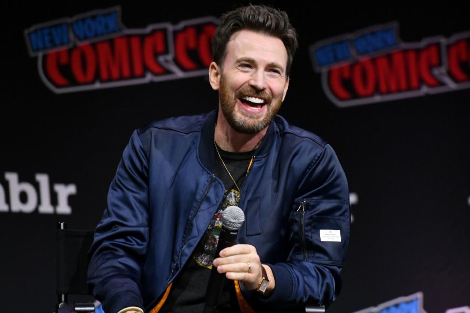 <p>Craig Barritt/Getty </p> Chris Evans speaks at a New York Comic Con 2023 panel.