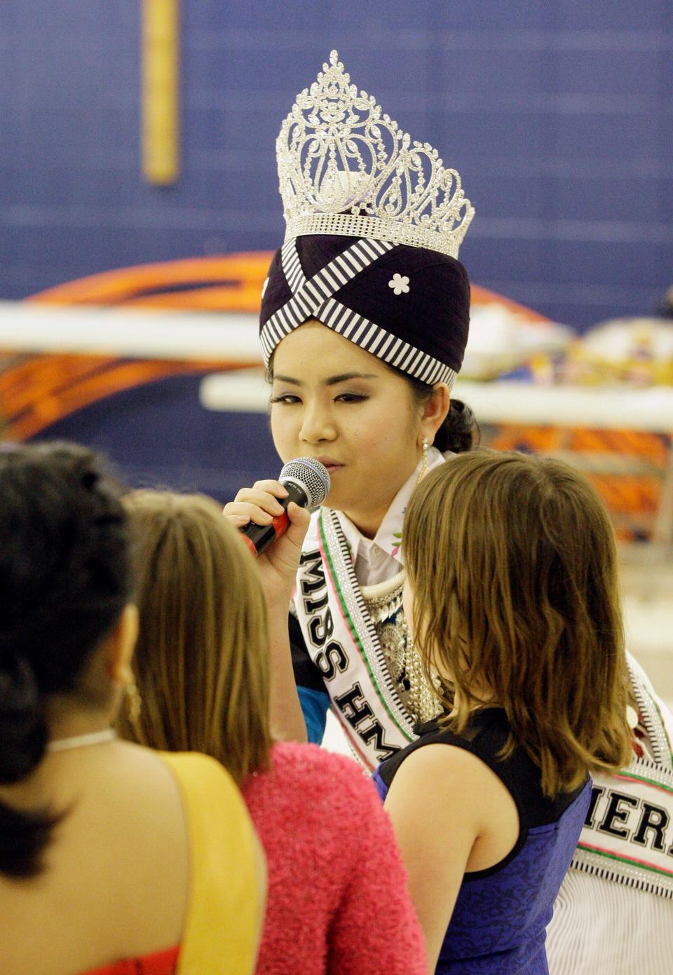 Today, the phuam txoo suab is more hat than headwrap. It’s often sold pre-wrapped, and it might be embroidered with silver coins or shiny beads. The headwrap’s evolution parallels Milwaukee’s Hmong community in some ways. Today’s young generation fuses American culture with the traditions of their parents and grandparents, who fled Laos as refugees in the 1970s and '80s.