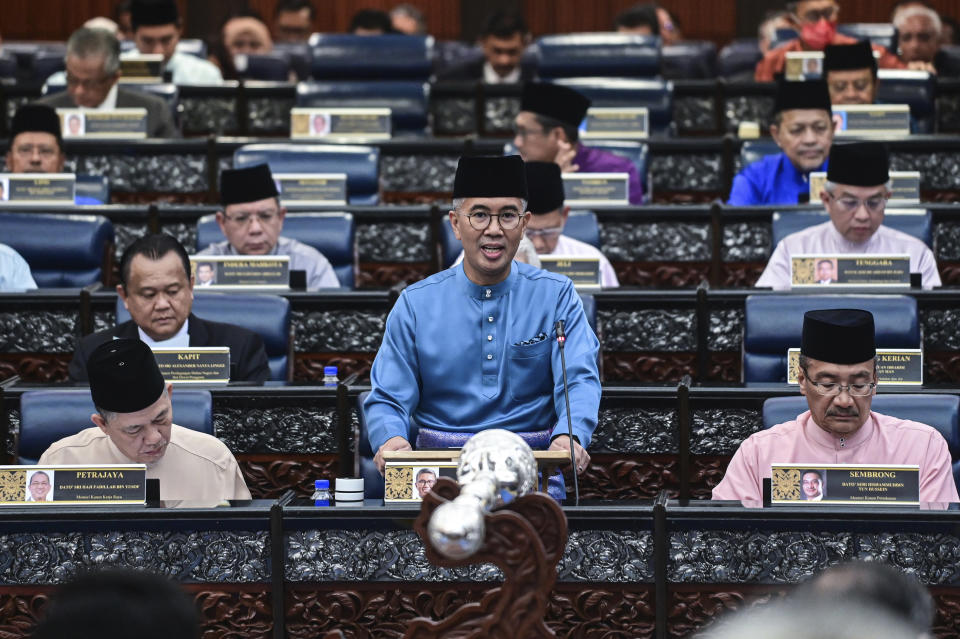 In this photo released by Malaysia's Department of Information, Malaysia's Finance Minister Zafrul Aziz, center, delivers the 2023 budget speech at parliament in Kuala Lumpur, Malaysia, Friday, Oct. 7, 2022. (Nizam Zanilni/Malaysia Department of Information via AP)