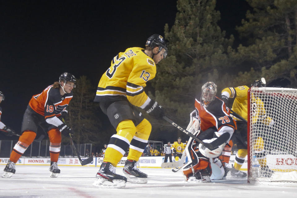 <p>STATELINE, NEVADA - FEBRUARY 21: Charlie Coyle #13 of the Boston Bruins scores a second period goal past Carter Hart #79 of the Philadelphia Flyers during the 'NHL Outdoors At Lake Tahoe' at the Edgewood Tahoe Resort on February 21, 2021 in Stateline, Nevada. (Photo by Christian Petersen/Getty Images)</p> 