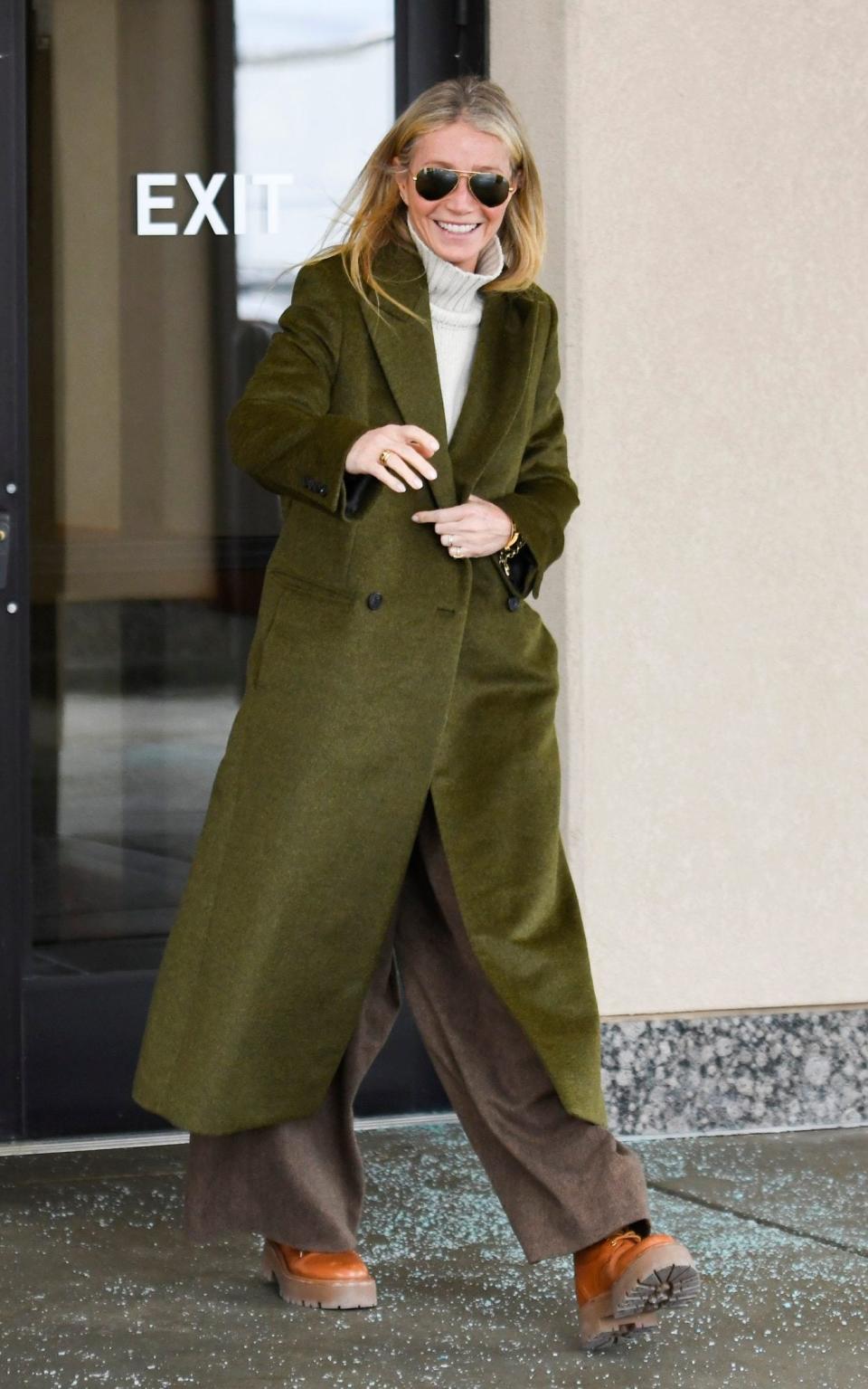 On the opening day, she wore an olive green coat and Annie Hall trousers that look Max Mara-esque, in a soft wool herringbone - Alex Goodlett