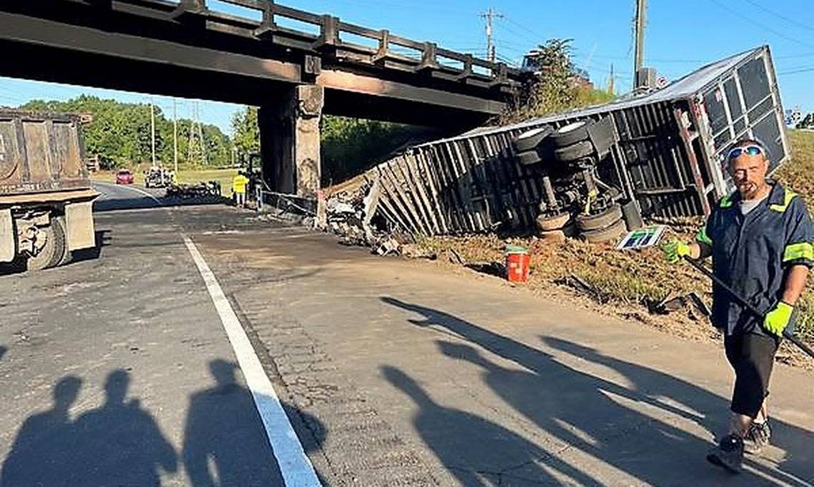 Crews prepare to remove the remains of a tractor-trailer that crashed into the N.C. 86 bridge over Interstate 85 just after 2 a.m. Wednesday, Sept. 14, 2022. The driver of the rig was killed in the crash.