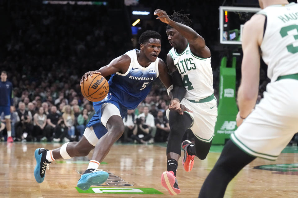 Minnesota Timberwolves guard Anthony Edwards (5) drives to the basket against Boston Celtics guard Jrue Holiday (4) during the second half of an NBA basketball game Wednesday, Jan. 10, 2024, in Boston. (AP Photo/Charles Krupa)