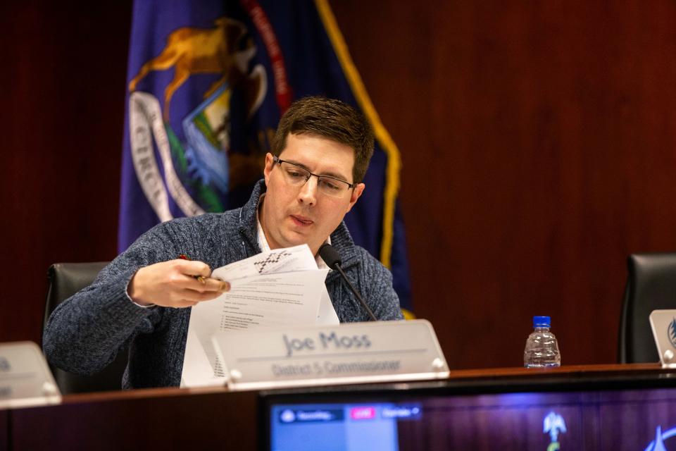 Ottawa County Board Chair Joe Moss flips through a packet of papers during a meeting Tuesday, Feb. 28, 2023, in West Olive.