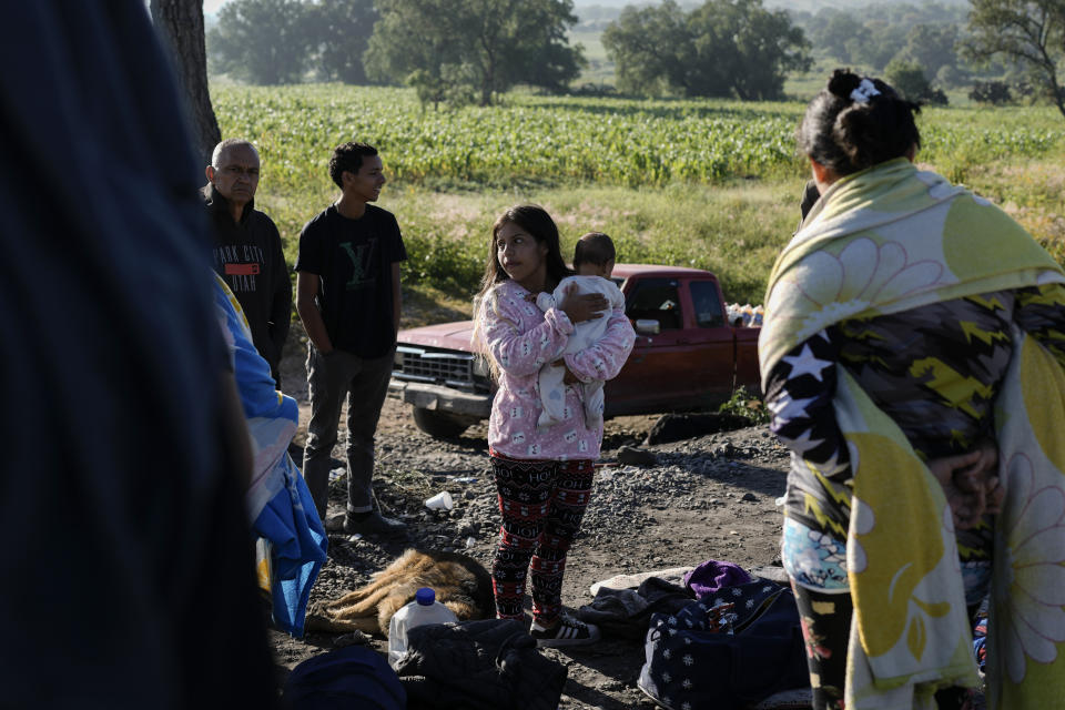 Migrants wait along the rail lines in hopes of boarding a freight train heading north in Huehuetoca, Mexico, Wednesday, Sept. 20, 2023. (AP Photo/Eduardo Verdugo)