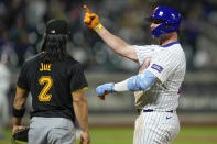 New York Mets' Pete Alonso, right, reacts after hitting a single, next to Pittsburgh Pirates' Connor Joe, left, during the seventh inning of a baseball game Tuesday, April 16, 2024, in New York. (AP Photo/Seth Wenig)