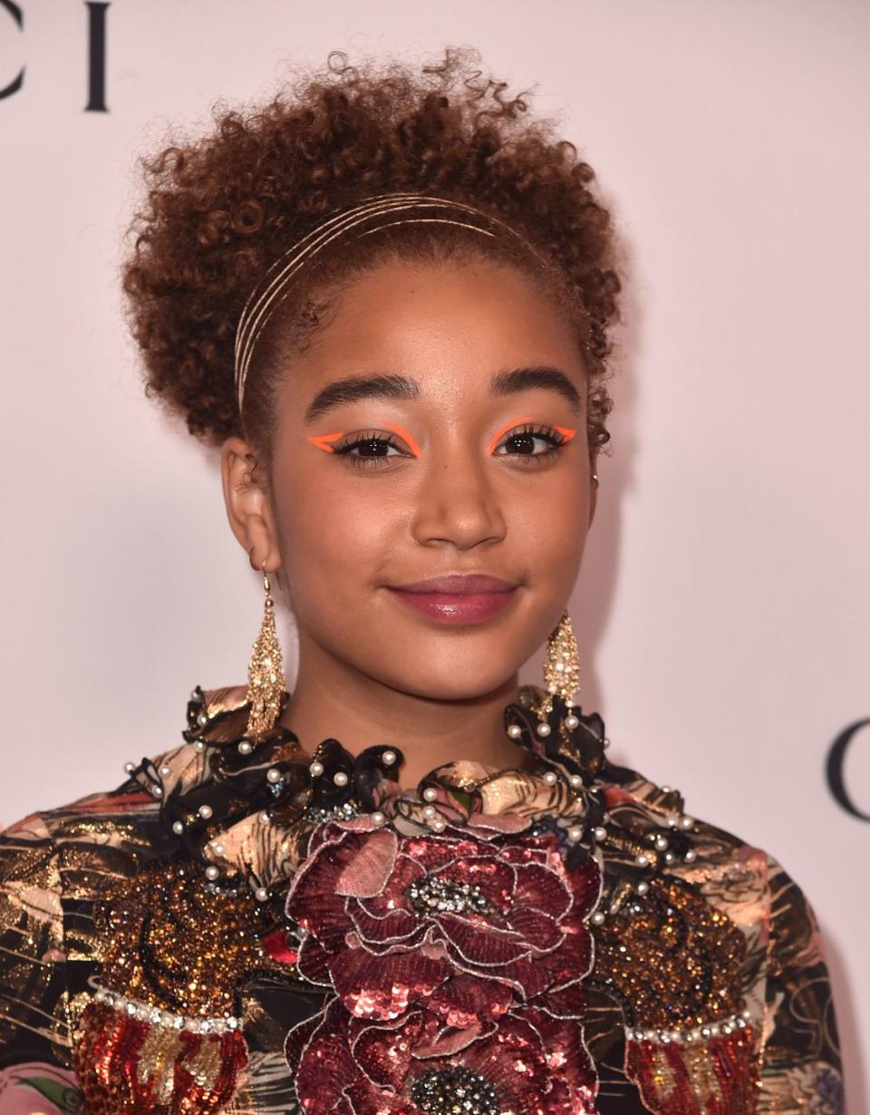 <p>If you are running short on time and still want an elegant look, wear your naturally curly hair up. Instead of using a hair tie, opt for gold string like <strong>Amandla Stenberg</strong> to add an elevated air. </p>